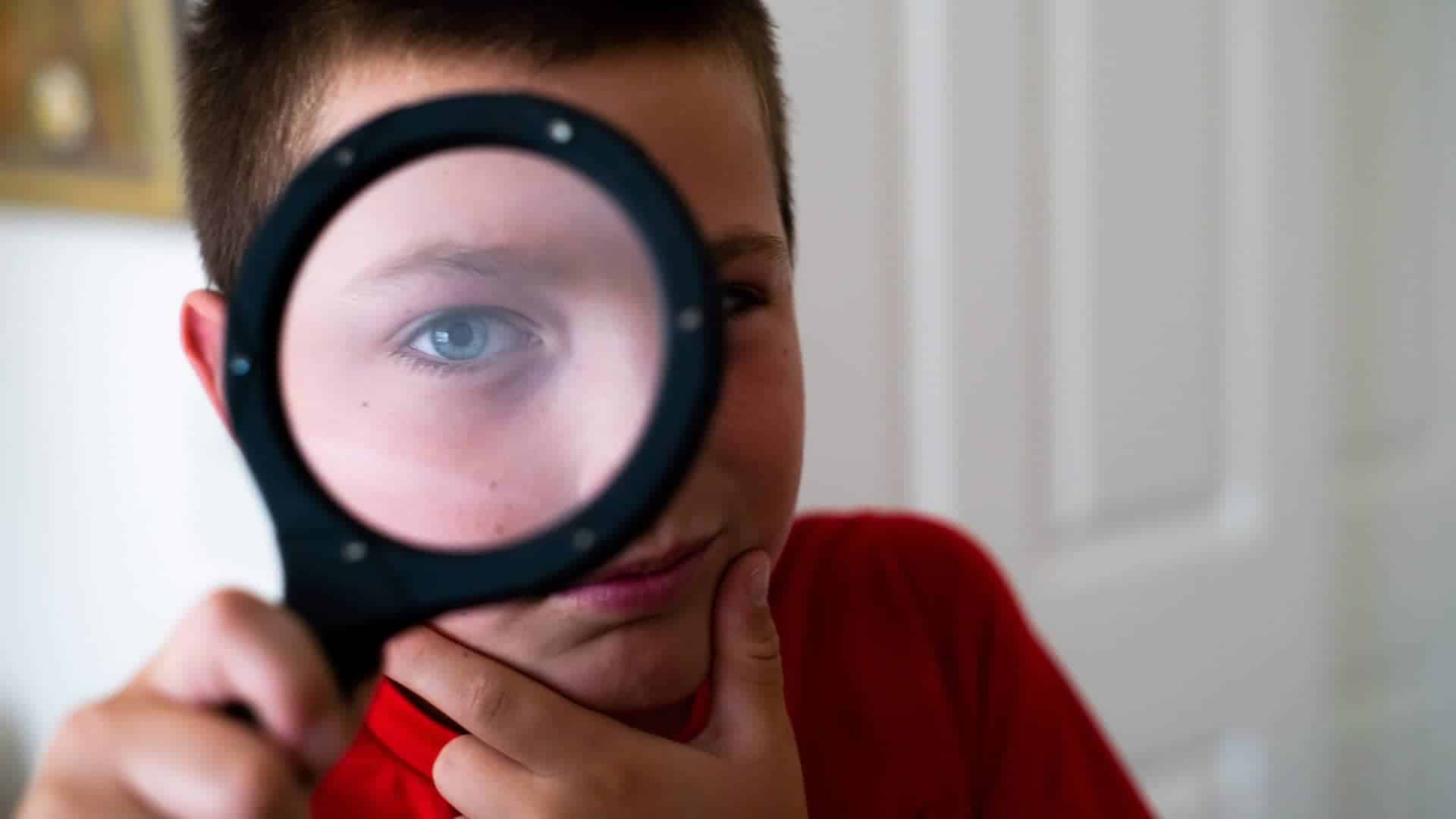 still of boy looking through looking glass